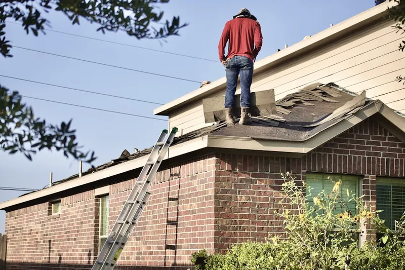 Professional roofer working on a residential roof in Shore Acres